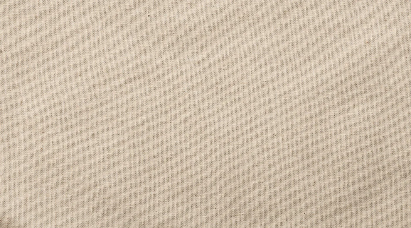 Close-up of the woven 140 g/m² natural cotton fabric, showing the fine surface texture and small speckles in the tote bag material.