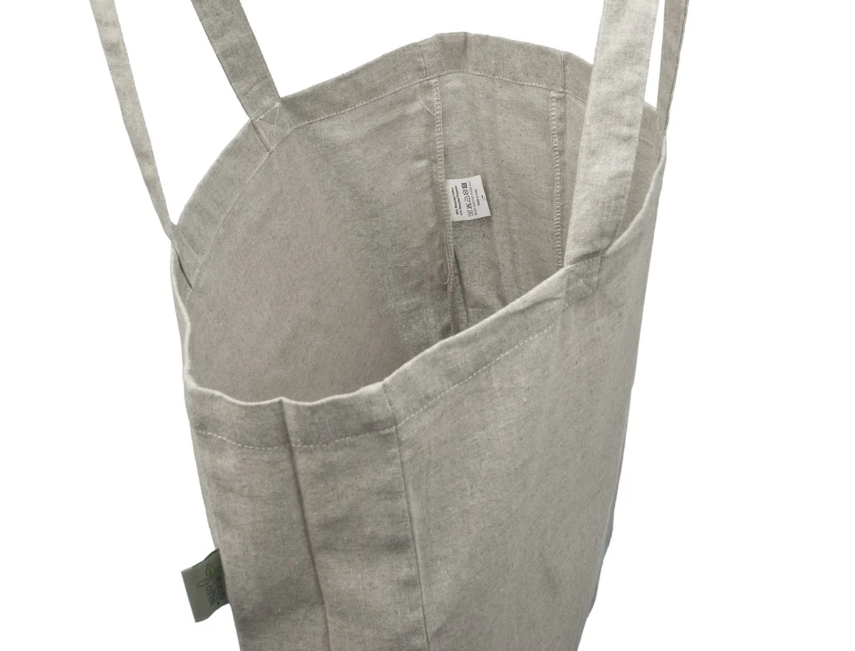 Inside view of the gray 220 g/m² cotton tote bag, showing the lining-free fabric, sewn seams and the small label attached inside.