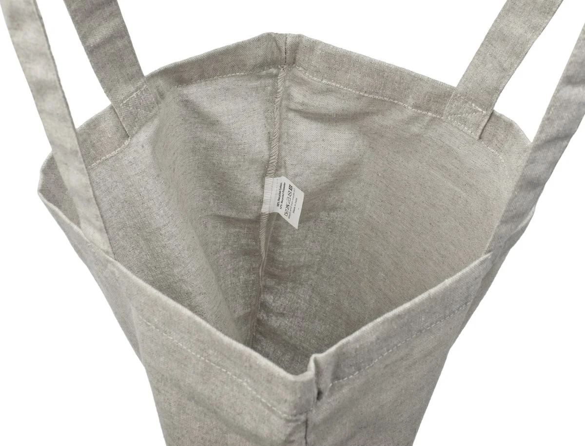 Inside view of the light gray 140 g/m² recycled tote bag, showing the lining-free fabric, sewn seams and the small label attached inside.